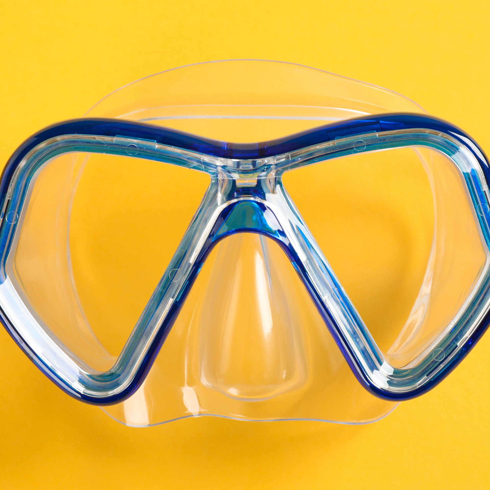 Yellow diving mask on a bright yellow background